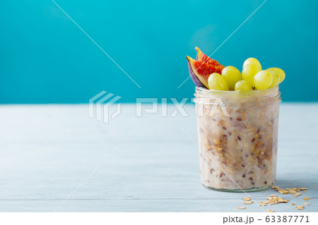 Overnight oats, bircher muesli with grape and figs. Blue background. Copy space. Overnight oats, bircher muesli with grape and figs. Blue background. Copy space. 63387771