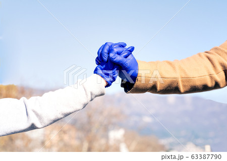 Man and child holding hands wearing medical gloves protection from Coronavirus 63387790
