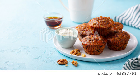 Carrot muffins with riccota cheese on a plate. Blue stone background. Copy space. 63387791