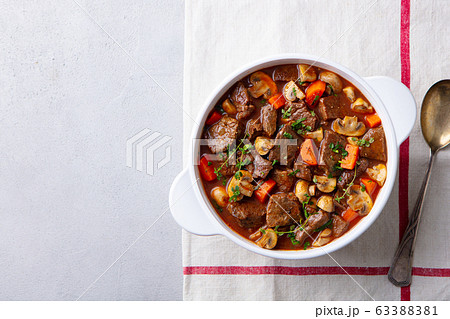Beef bourguignon stew with vegetables. Grey background. Copy space. Top view. Beef bourguignon stew with vegetables. Grey background. Copy space. Top view. 63388381