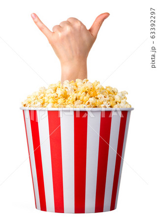 Female hand sticks out of a bucket with popcorn isolated on white background 63392297