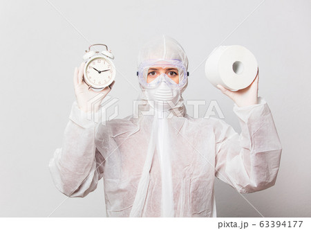 young doctor in protection suit and glasses with 63394177