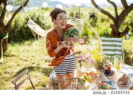 Woman preparing for the festive dinner outdoors 63394743