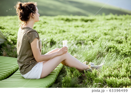 Woman with sunscreen lotion in the mountains Woman with sunscreen lotion in the mountains 63396499
