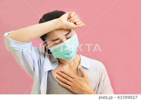 Young asian woman worea gray tank top, Blue shirt and protective masks against virus and air pollution,make gesture Coughing, isolated on pink background Young asian woman worea gray tank top, Blue shirt and protective masks against virus and air pollution,make gesture Coughing, isolated on pink background 63399027