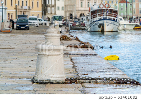 Old bollard at coastline 63401082