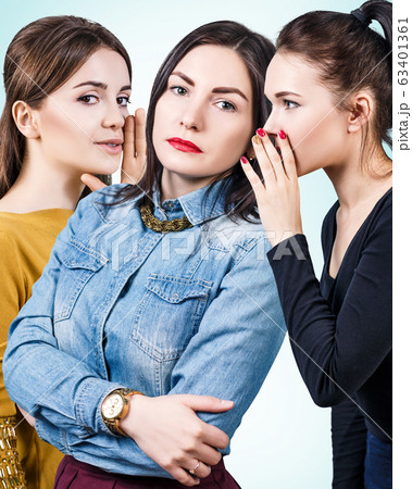 Young girls gossiping some secret. 63401361