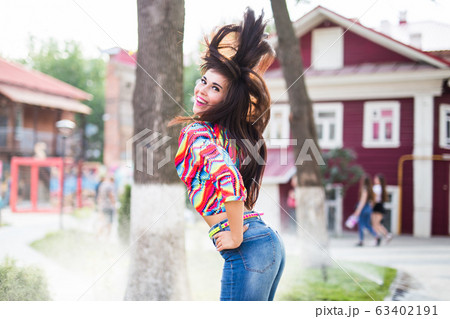 Beautiful attractive young woman having fun and enjoying and dancing in the park on a sunny summer day. Beautiful attractive young woman having fun and enjoying and dancing in the park on a sunny summer day. 63402191