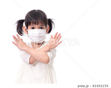 Asian little cute girl 4 years old wearing a hygienic face mask to protective spread the disease on white background. Prevention of spreading the corona virus COVID-19 cold flu or pollution. Asian little cute girl 4 years old wearing a hygienic face mask to protective spread the disease on white background. Prevention of spreading the corona virus COVID-19 cold flu or pollution. 63403259