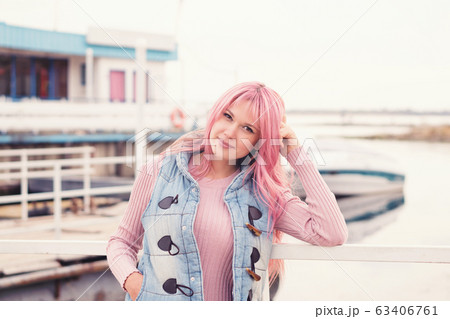 Portrait of a lovely pink-haired girl outdoors Portrait of a lovely pink-haired girl outdoors 63406761