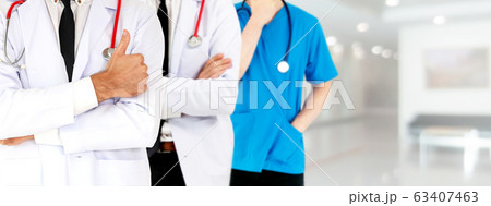 Doctor working in hospital with other doctors. 63407463