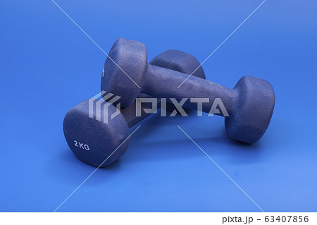 Couple of blue dumbbells on blue background 63407856