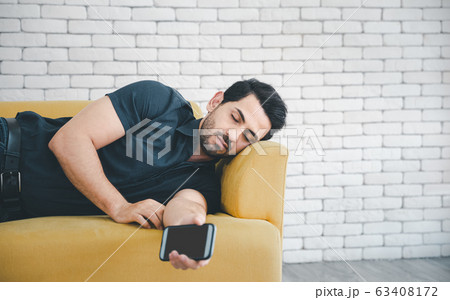 man napping with smart phone 63408172