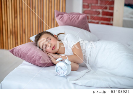 Teen girl sleeping in a big bed. Teen girl sleeping in a big bed. 63408922