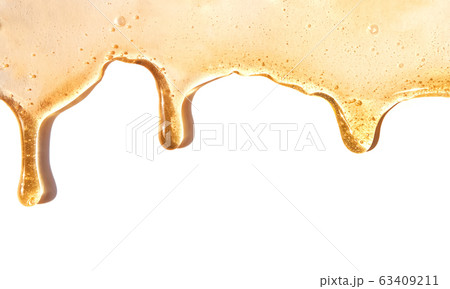 Flow of sweet honey on the white background 63409211