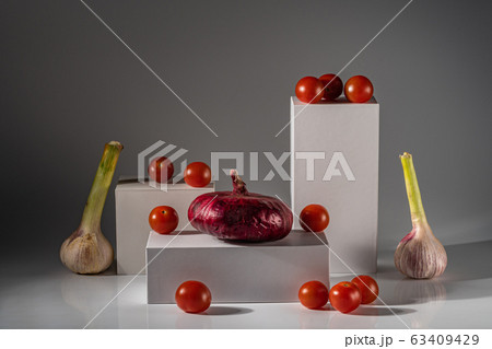 Still life with garlic, red onions, tomatoes on 63409429