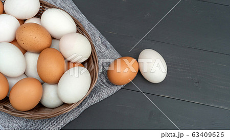 Chicken egg and duck egg on a black wooden table. Chicken egg and duck egg on a black wooden table. 63409626