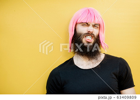 Man with color hair on the yellow background Man with color hair on the yellow background 63409809