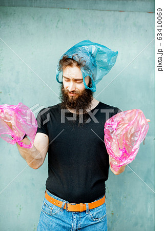 Conceptual portrait of a man with plastic bags 63410069