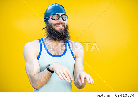 Portrait of a weird swimmer on the yellow background 63410674