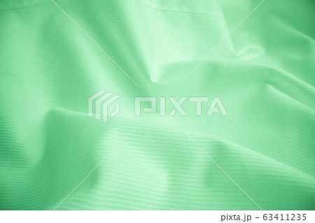 Shiny flowing cloth texture in macro shot. Shiny flowing cloth texture in macro shot. 63411235