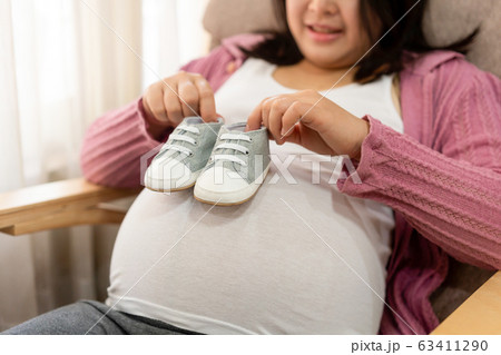 Happy pregnant woman and expecting baby at home. 63411290