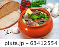 Roast in a pot with beef meat and potatoes on the table 63412554