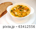 Chicken soup with meatballs and pasta on the table 63412556