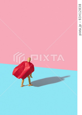 Wooden mannequin model in a red cape as a superhero with shadow. 63412838