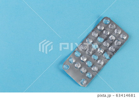 Used blister pack from tablets medicine on blue background. 63414681