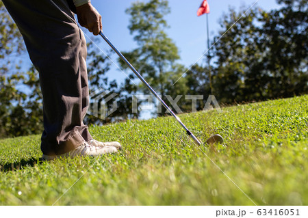 Man playing golf on a golf course. Man playing golf on a golf course. 63416051
