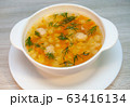 Chicken soup with meatballs and pasta on the table 63416134