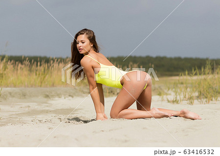 Sexy female in bright swimsuit on beach Sexy female in bright swimsuit on beach 63416532
