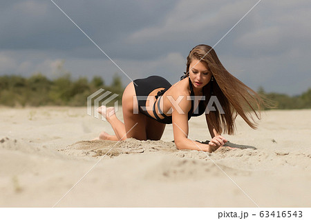 Gorgeous Young Female Crawling on Beach Stock Photo - Image of black, chic:  212961224