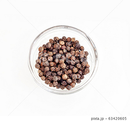 Small pile of black pepper isolated on white Small pile of black pepper isolated on white 63420605