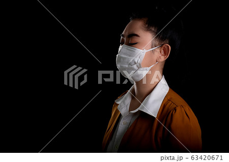 woman putting on a respirator N95 mask to protect from airborne respiratory diseases as the PM2.5 woman putting on a respirator N95 mask to protect from airborne respiratory diseases as the PM2.5 63420671