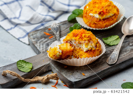 Traditional carrot mini cakes in paper capsules. Traditional carrot mini cakes in paper capsules. 63421542