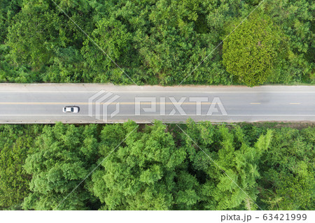 Aerial view of the road passing the forest with a Aerial view of the road passing the forest with a 63421999