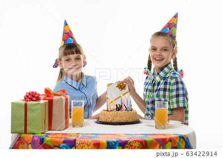 Girlfriend gives a birthday girl a gift 63422914