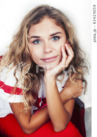 young pretty teenage hipster girl posing emotional happy smiling on white background, lifestyle people concept 63424059