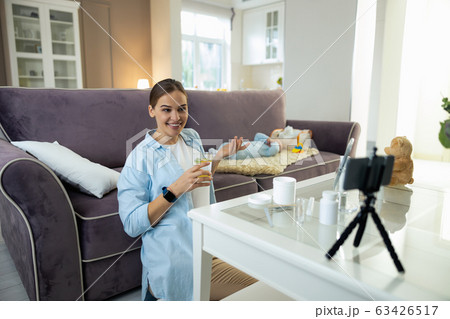 Smiling attractive woman making video for her vlog in room 63426517