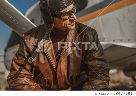 Handsome stylish man resting near airplane outdoors Handsome stylish man resting near airplane outdoors 63427691