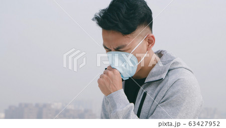 man coughs and wears mask man coughs and wears mask 63427952