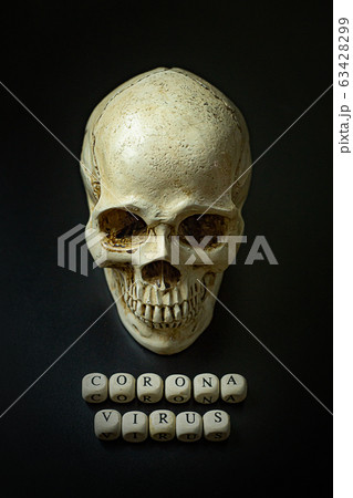 The corona virus  wooden cube and skull  on black background for medical content. 63428299