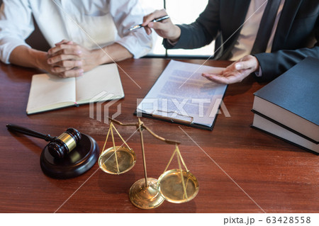 Lawyer working with client discussing contract Lawyer working with client discussing contract 63428558