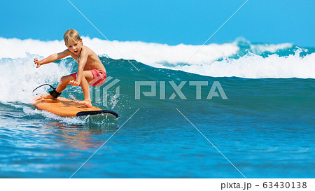 Young surfer learn to ride on surfboard on sea 63430138