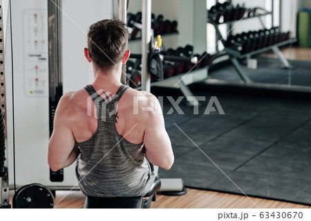 Man doing exercise on rowing machine Man doing exercise on rowing machine 63430670