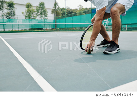 Tennis player taking ball Tennis player taking ball 63431247