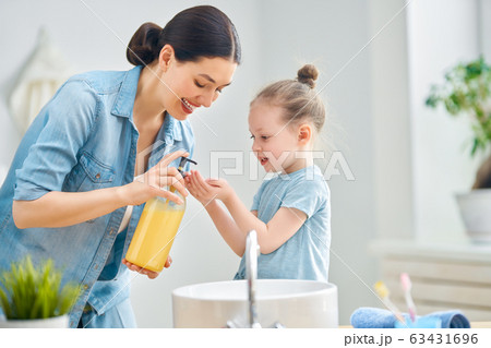 girl and her mother are washing hands girl and her mother are washing hands 63431696