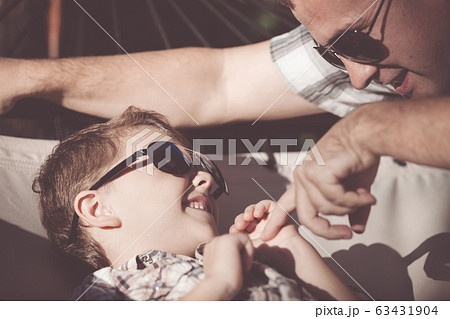 Father and son playing in the park at the day 63431904